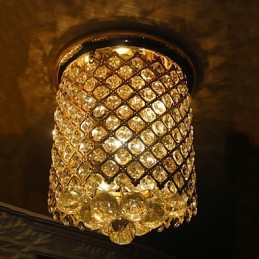 Lámpara de techo moderna de cristal con acabado dorado y forma espiral.
